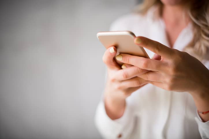 Resident holding their phone.