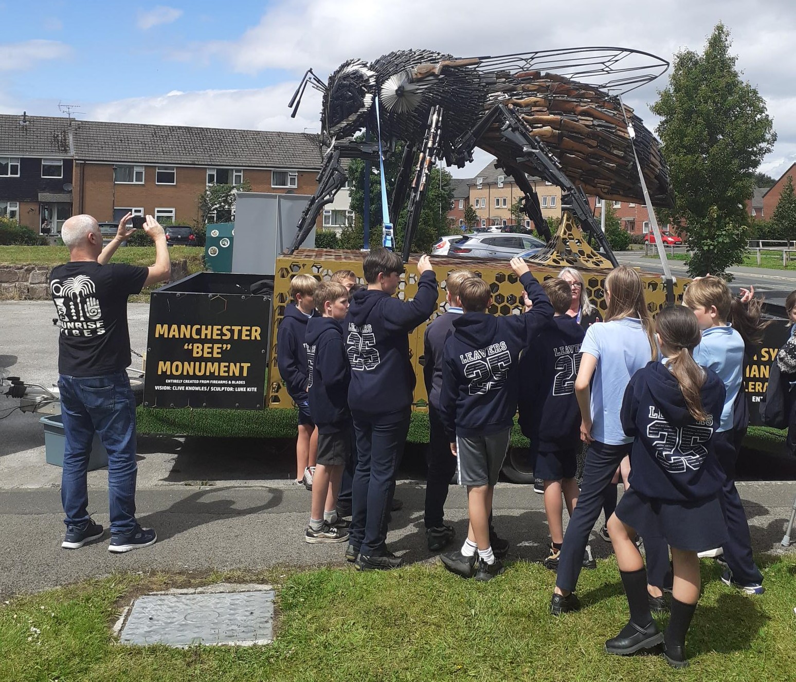 A photo of pupils with the Manchester Bee on a trailer