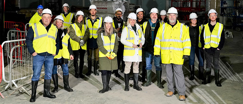 Group of traders wearing high vis clothing and hardhats