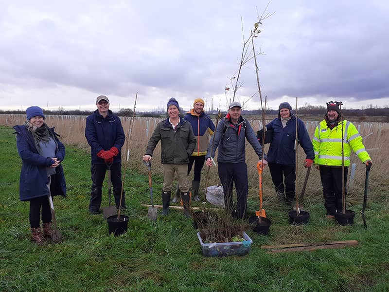 7 members of the Total Environment Team preparing for tree planting in Picton