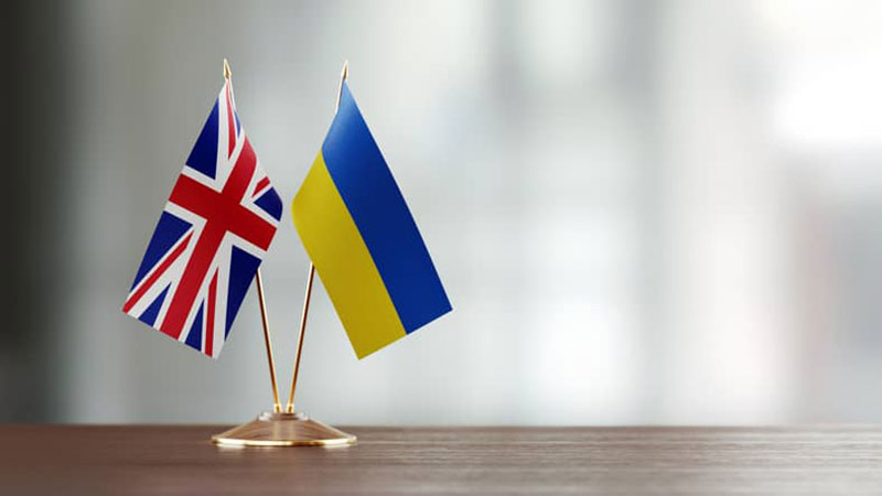 British and Ukrainian flag pair on a desk.