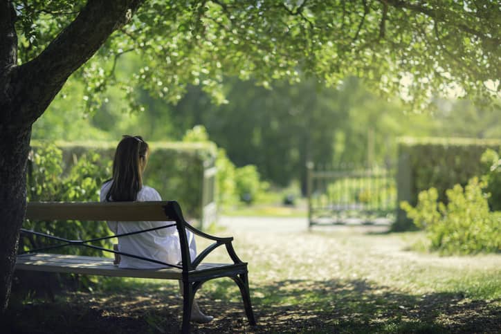 Woman sat on park bench