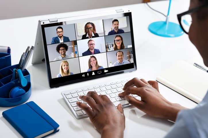 Carer using laptop whilst on an online meeting with colleagues