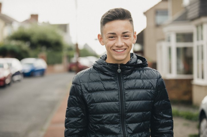 Young resident on street wearing black coat